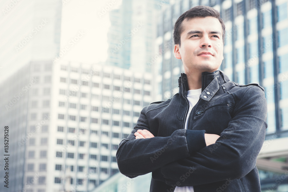 Handsome man standing with arms crossed in the city Handsome man standing with arms crossed in the city