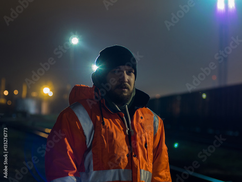 Portrait of young construction worker at night.