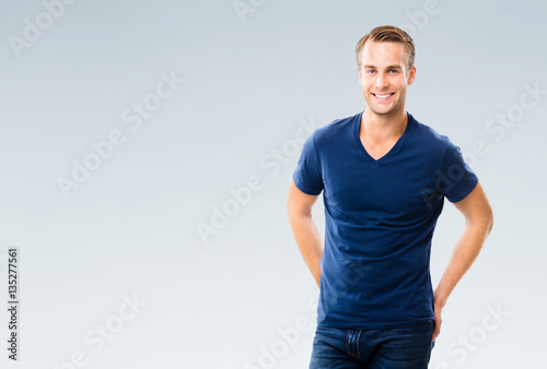 Cheerful young man, over grey
