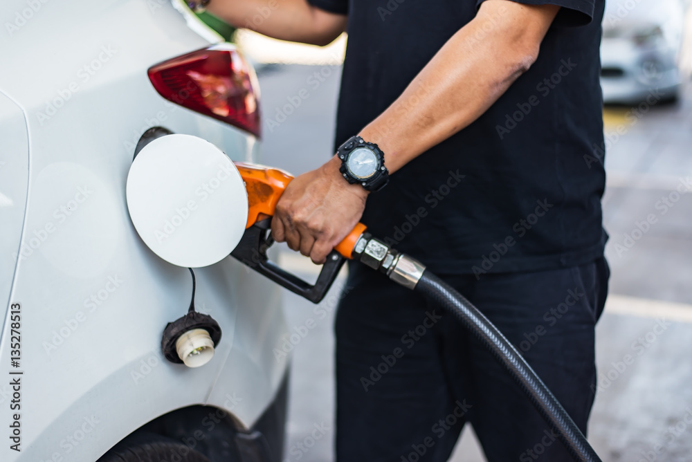 Car refueling on petrol station. Man pumping gasoline oil.