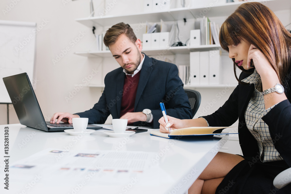 Employees concentrating on work in a modern office Employees concentrating on work in a modern office
