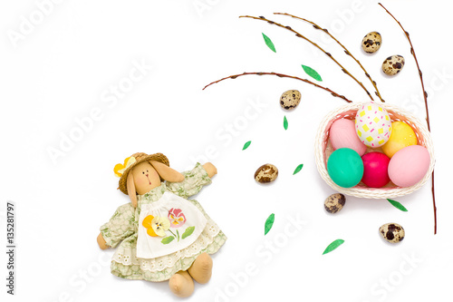 quail eggs, Easter Bunny, willow branches and colorful eggs in basket on white background.