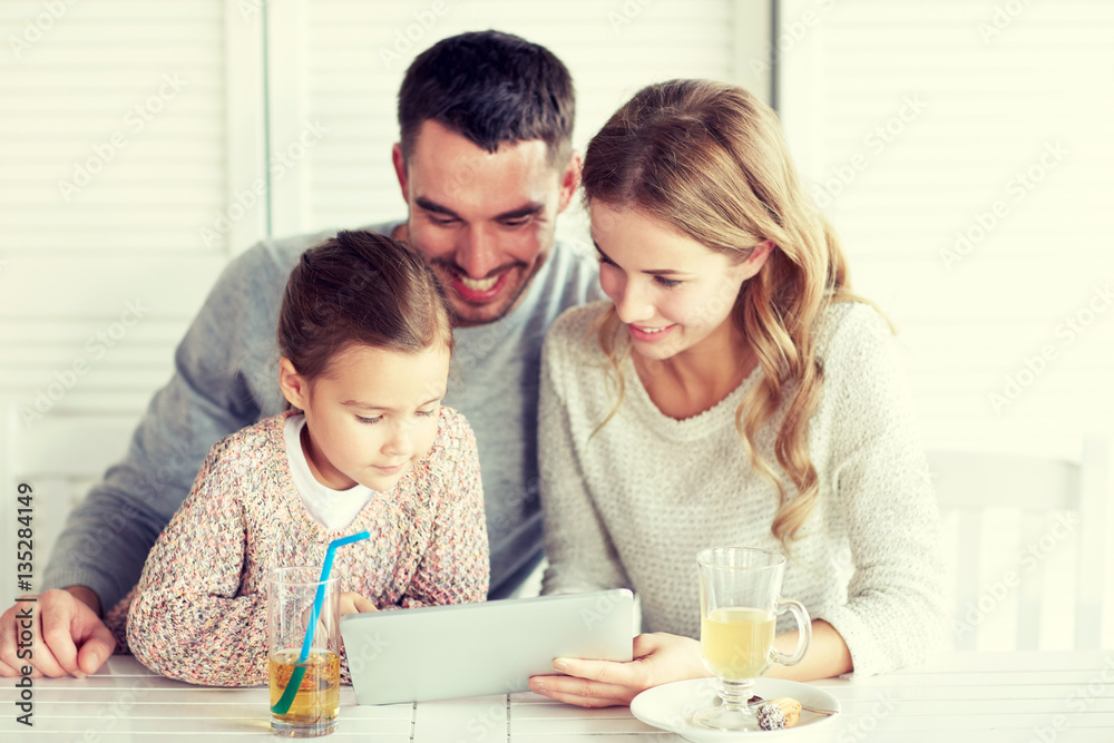 happy family with tablet pc at restaurant happy family with tablet pc at restaurant