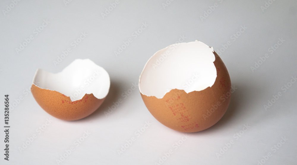 Brown broken Easter egg on a light background Brown broken Easter egg on a light background