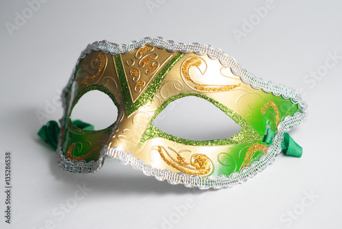 yellow and green Venetian mask on white background