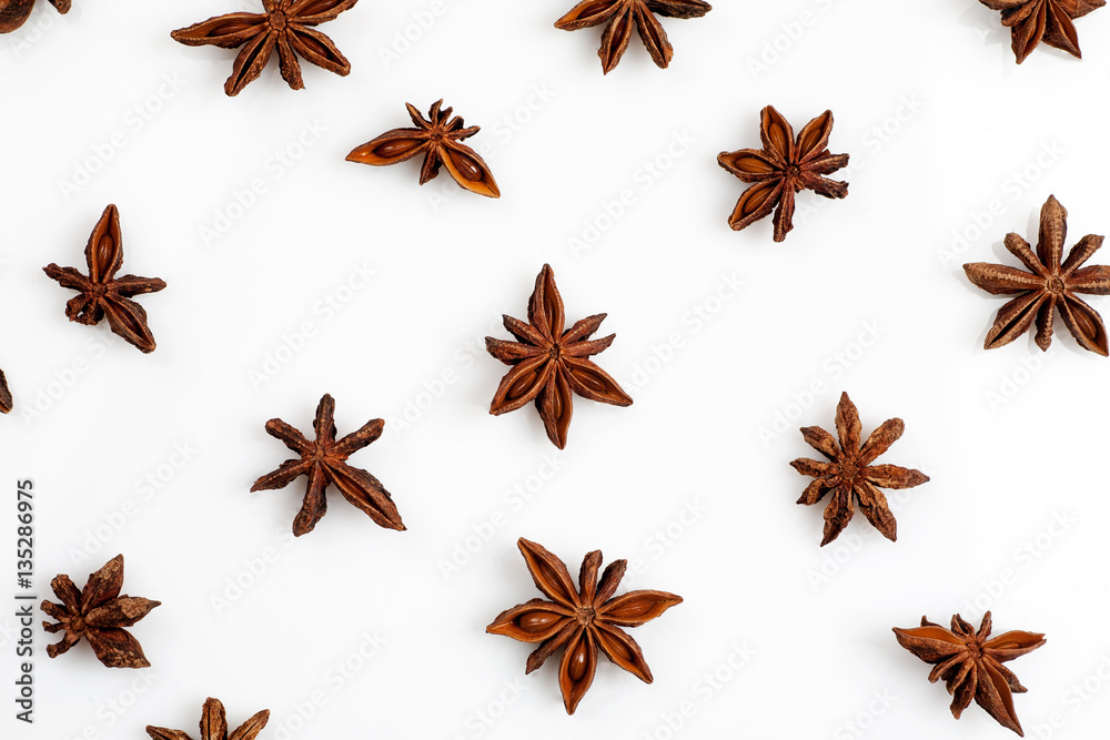 Fototapeta premium Close-up shot of star anise flat lay pattern isolated on white.