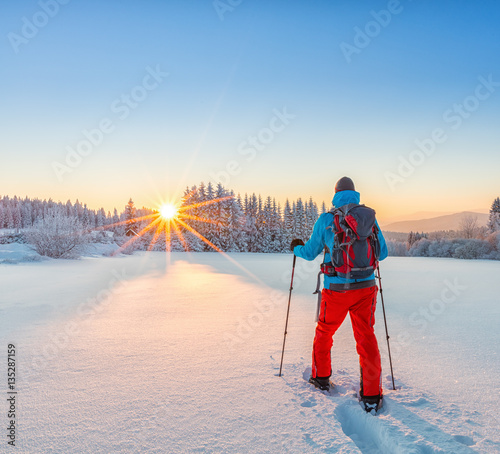 Snowshoe walker running in powder snow photo