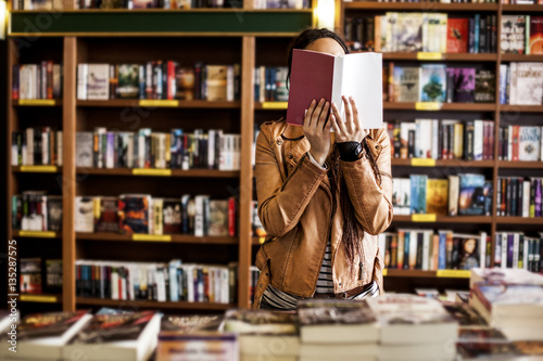Woman Reading at a Bookstore photo