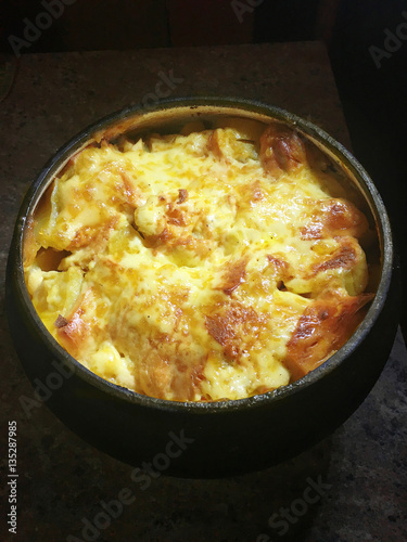 Potatoes with cheese and meat cooked in Russian stove