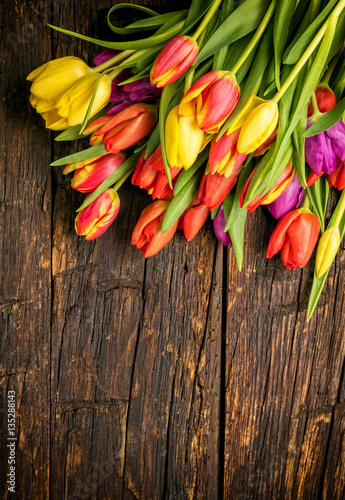 Bouquet of colorful tulips on rustic wooden planks