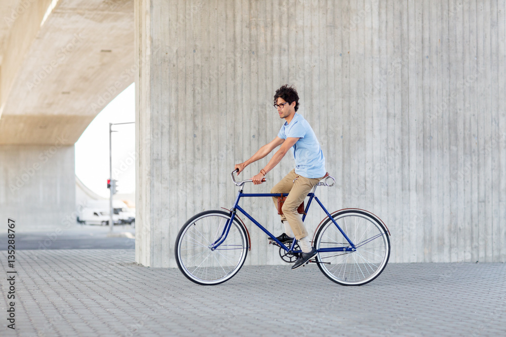 young hipster man riding fixed gear bike young hipster man riding fixed gear bike