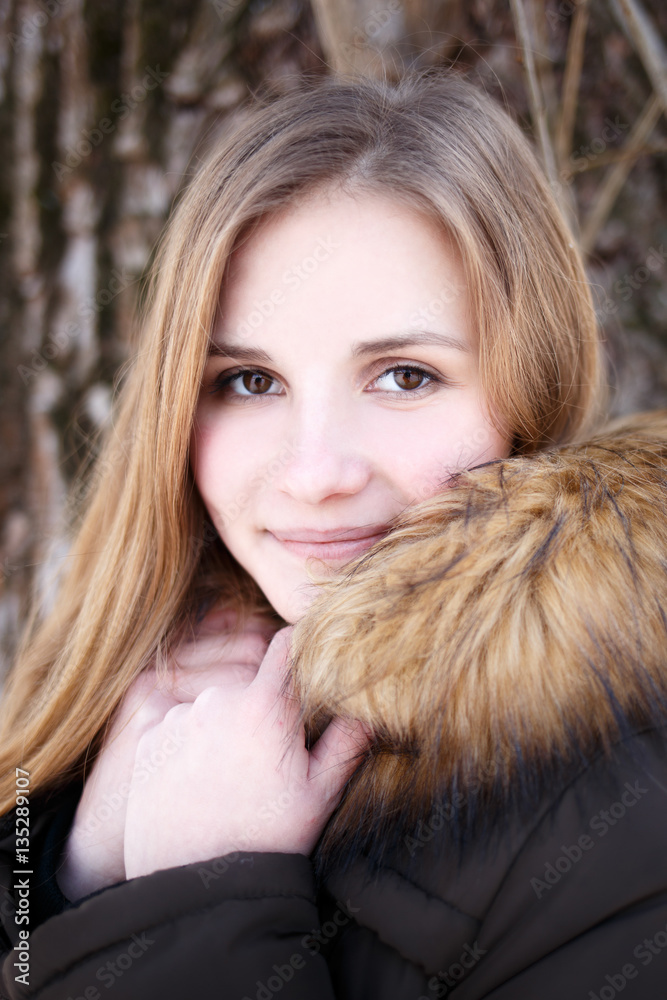 Portrait of Young smiling girl with long hair in winter park Portrait of Young smiling girl with long hair in winter park