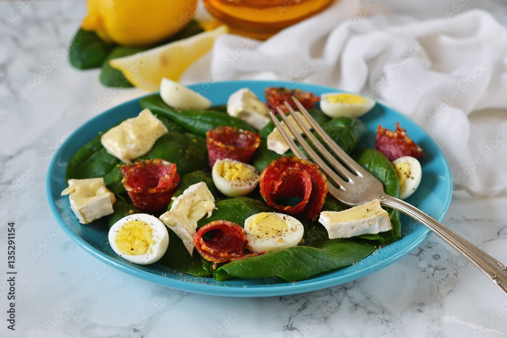Salad with spinach, brie cheese and quail eggs 