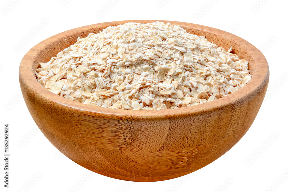 oat flakes in wooden bowl isolated on white oat flakes in wooden bowl isolated on white