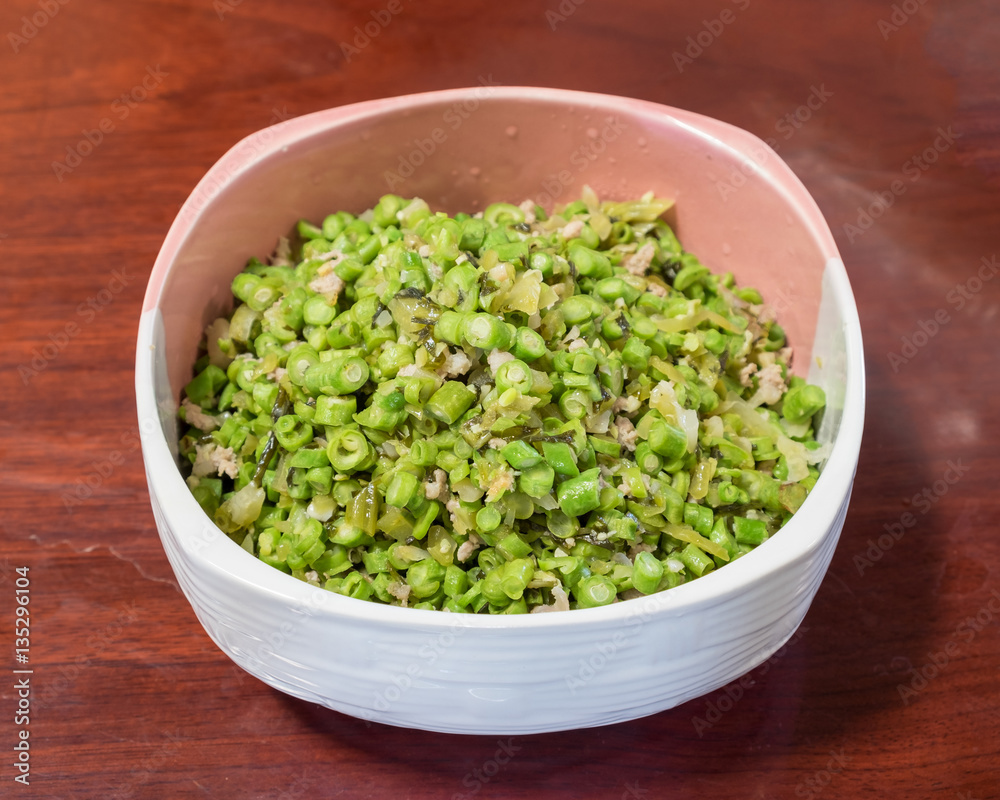 Cowpea sliced with sauerkraut and pork chops puff in bowl Cowpea sliced with sauerkraut and pork chops puff in bowl