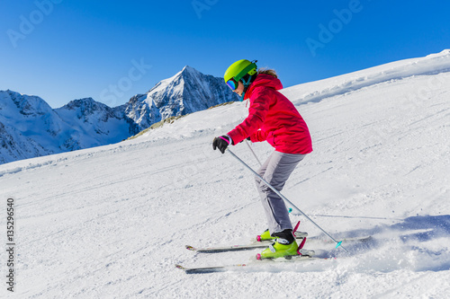 Teenage girl skiing in mountain ski piste track in Solda/Sulden,