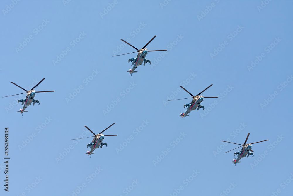 Mi-24 (Hind) large gunship and attack helicopters and low-capacity troop transportы fly against blue sky background
Mi-24 (Hind) large gunship and attack helicopters and low-capacity troop transportы fly against blue sky background