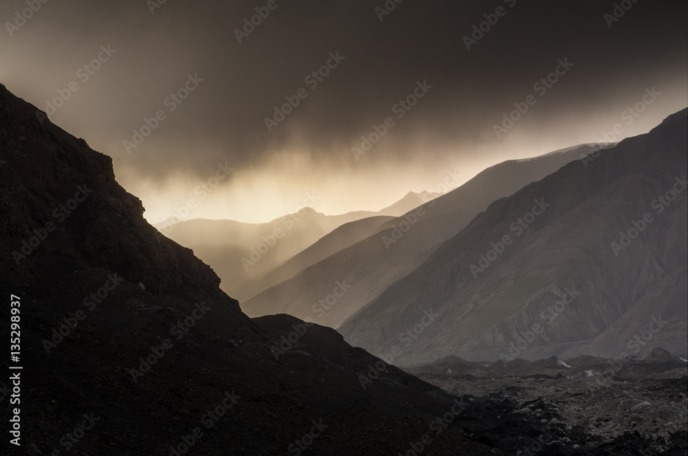 Beautiful sunset in mountains with fog and mountain silhouette