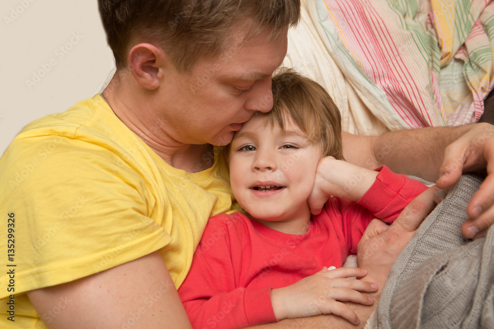 the father embraces the little son and cheerfully spend time. Fa the father embraces the little son and cheerfully spend time. Fa