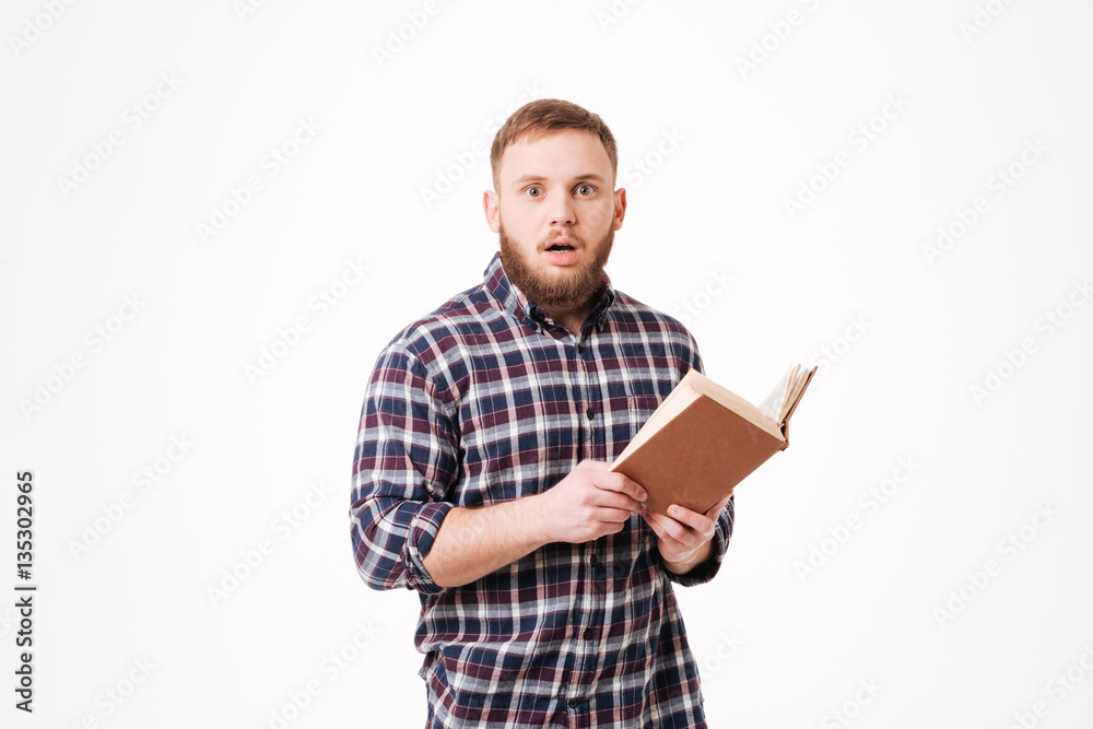 Surprised Bearded man in shirt holding book Surprised Bearded man in shirt holding book