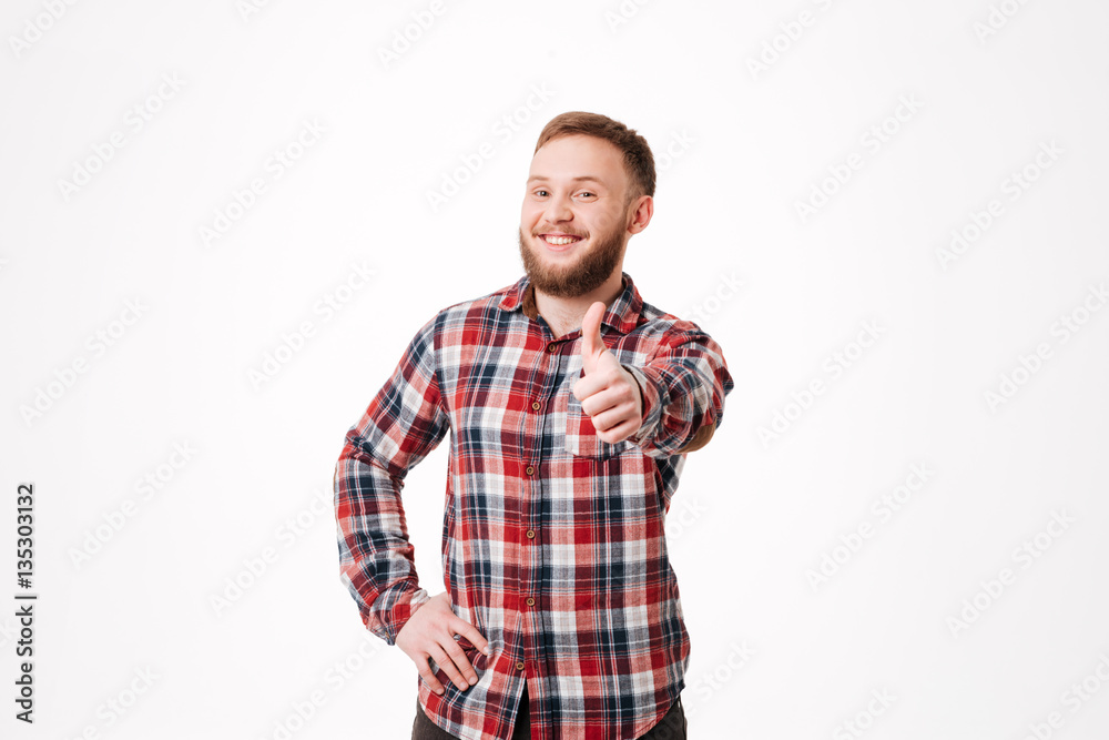 Smiling Bearded man in shirt showing thumb up Smiling Bearded man in shirt showing thumb up