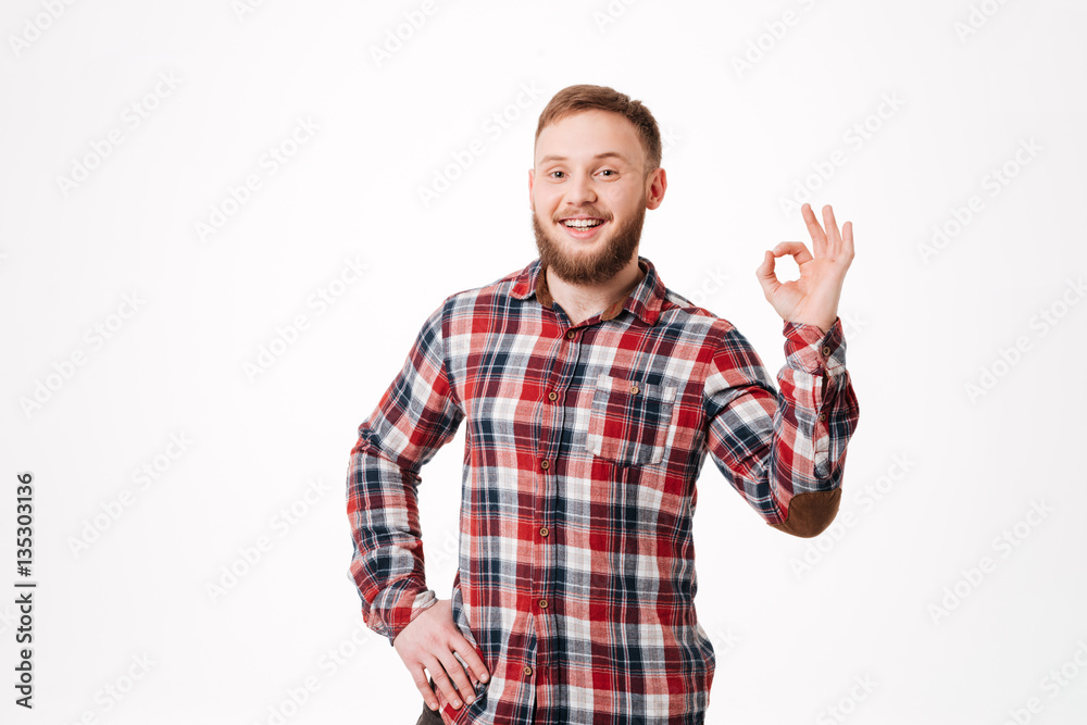 Fototapeta premium Smiling Bearded man in shirt showing ok sign
