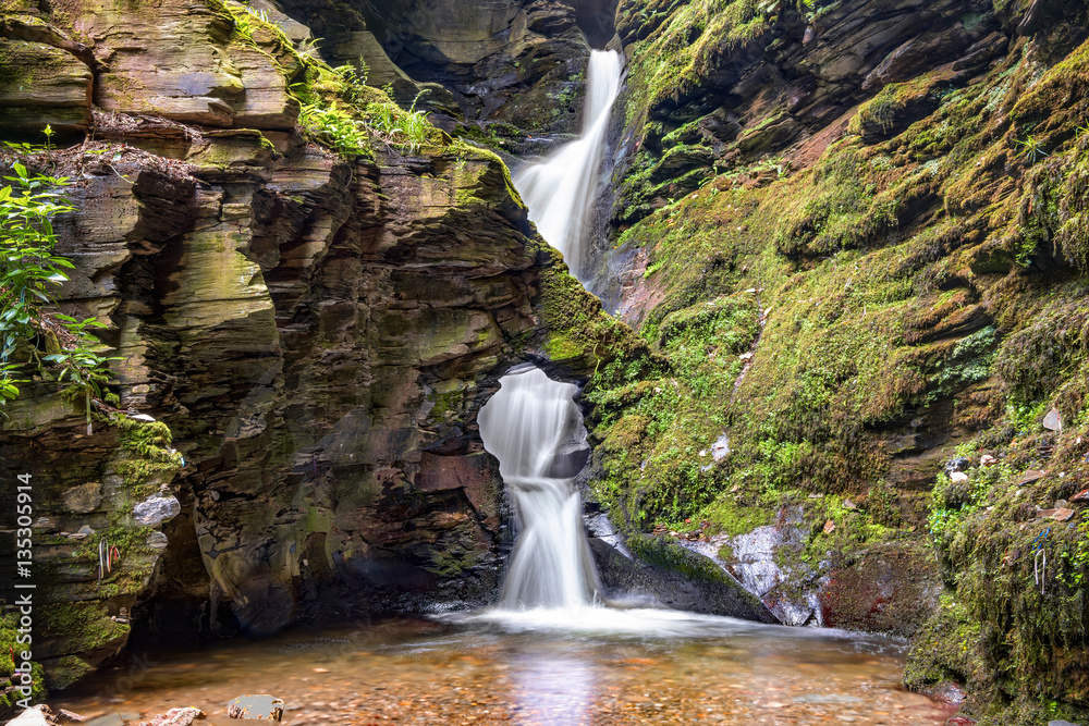 Fototapeta premium St Nectans Kieve waterfall in St Nectan's Glen valley in North Cornwall
