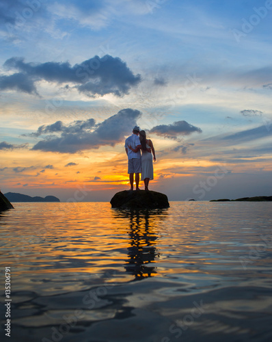 Couple in love see sunset at the Thailand sea