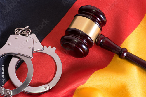 Handschellen, Richterhammer und die deutsche Nationalfahne photo