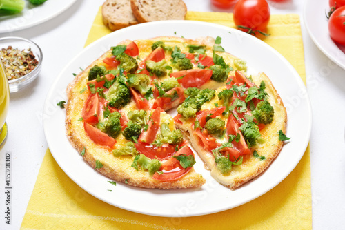 Omelet with broccoli, tomato, onion, parsley