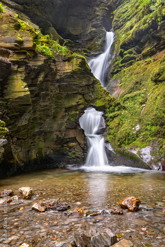 Fototapeta premium St Nectans Kieve waterfall in St Nectan's Glen valley in North Cornwall