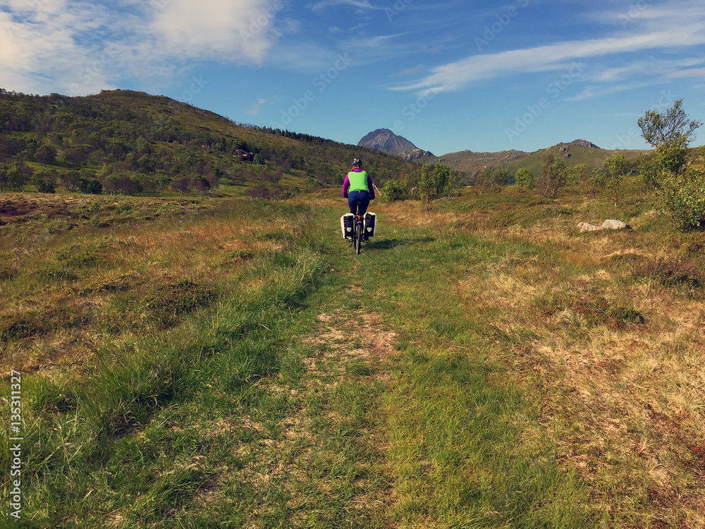 Biking on offroad trail on Lofoten Islands in Norway