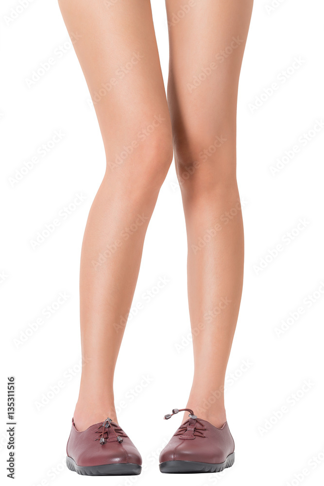 Woman beautiful long legs and healthy skin in standing legs pose wearing vintage fashion leather shoes, Isolated on white background. Woman beautiful long legs and healthy skin in standing legs pose wearing vintage fashion leather shoes, Isolated on white background.