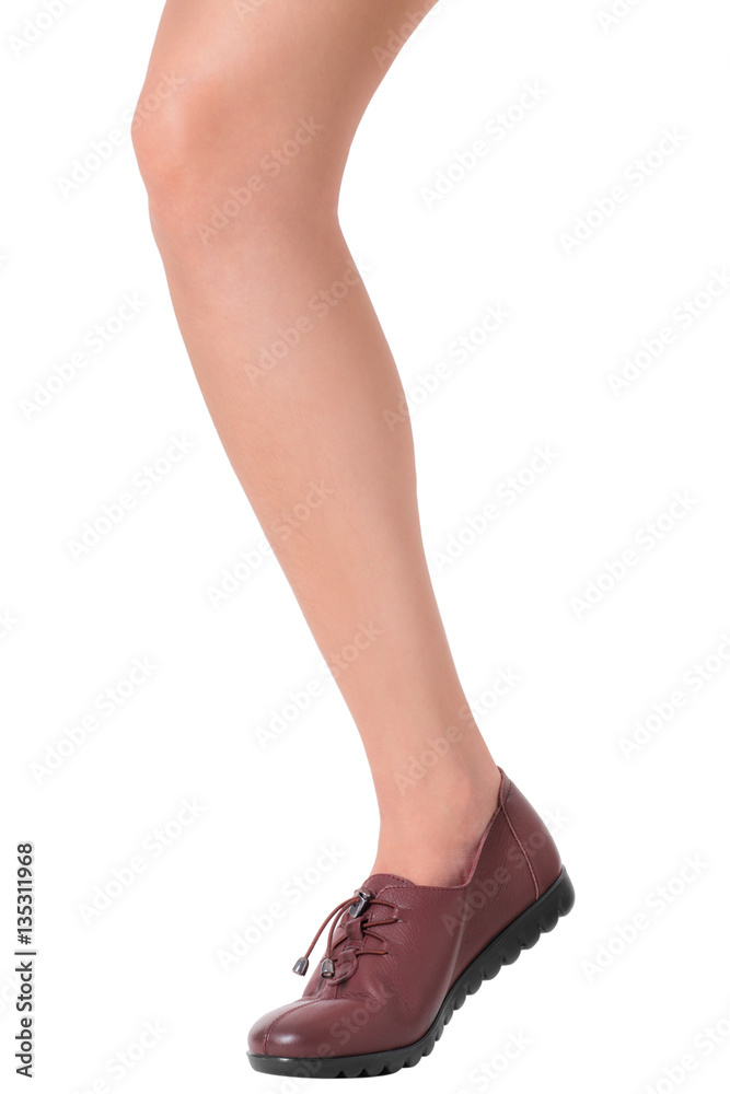 Woman beautiful long legs and healthy skin in standing legs pose wearing vintage fashion leather shoes, Isolated on white background. Woman beautiful long legs and healthy skin in standing legs pose wearing vintage fashion leather shoes, Isolated on white background.