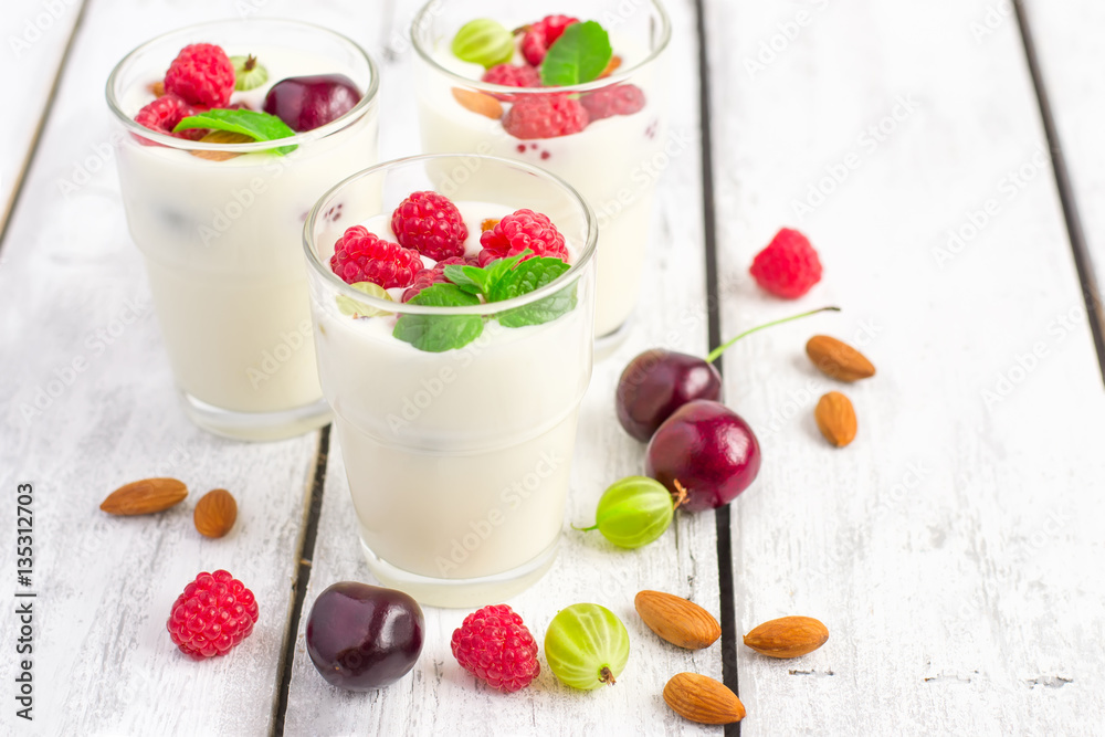Homemade yoghurt with summer berries and almonds, selective focu Homemade yoghurt with summer berries and almonds, selective focu