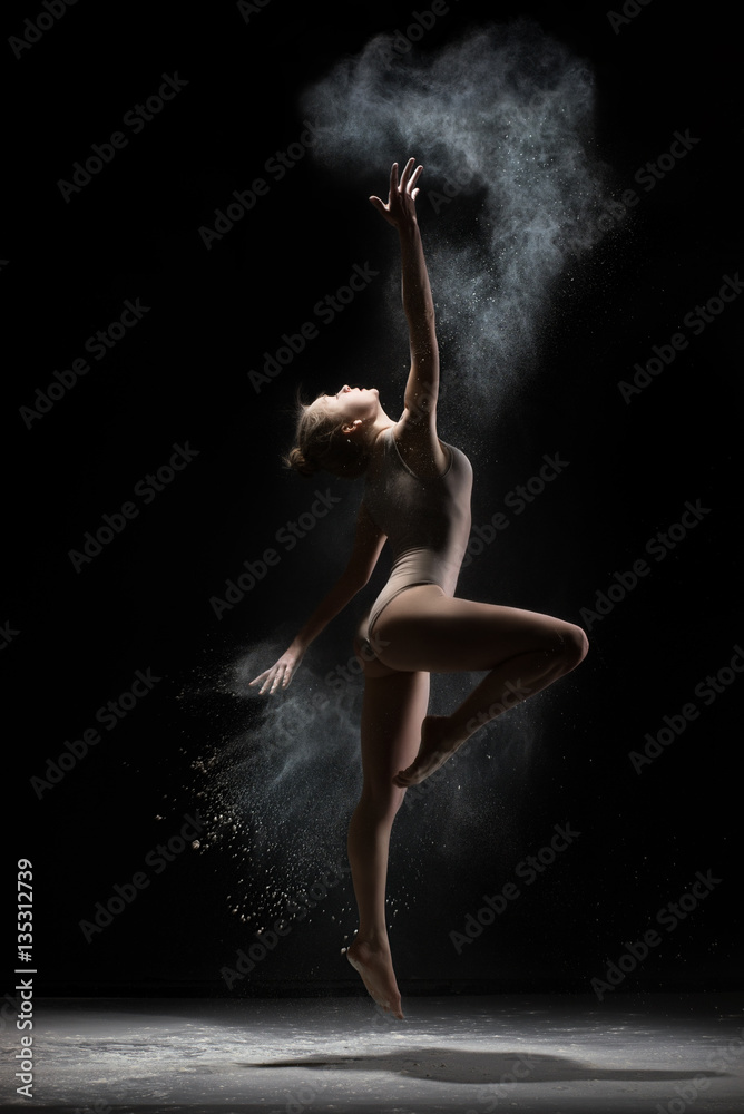 Female gymnast dances in cloud of white powder