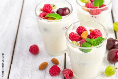 Homemade yoghurt with summer berries and almonds, selective focu