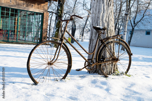 Old bicycle lost in the snow