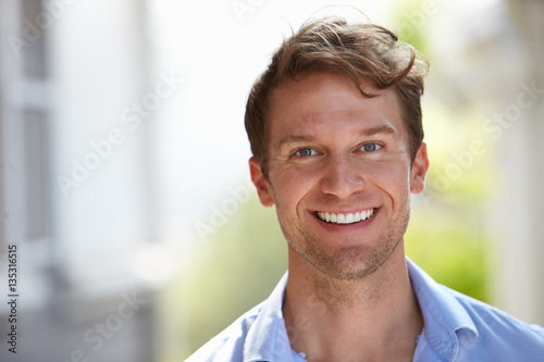 Fotografie Outdoor Head And Shoulders Portrait Of Smiling Man