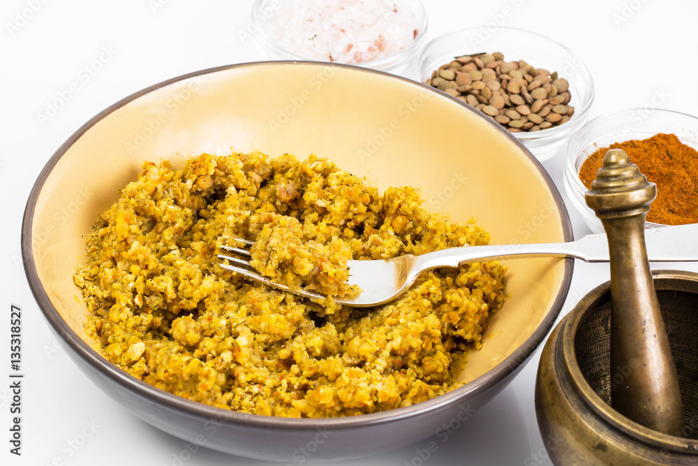 Lentil porridge with butter in a ceramic bowl on a white backgro Lentil porridge with butter in a ceramic bowl on a white backgro