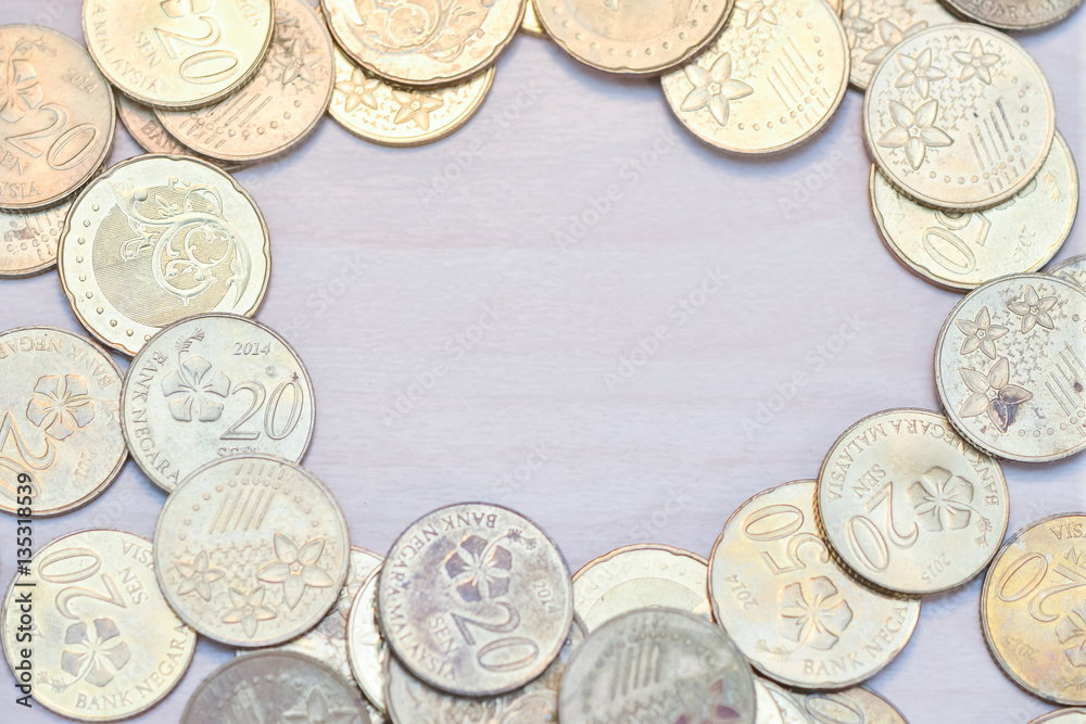 Frame of coins with copy space on centre with wooden background. Frame of coins with copy space on centre with wooden background.