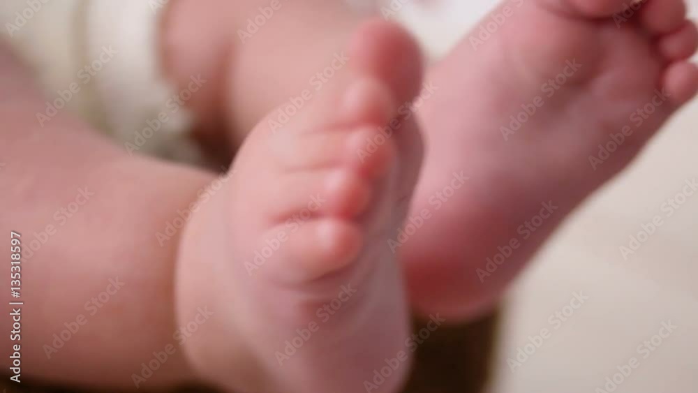 mom tickles the heels of the child mom tickles the heels of the child