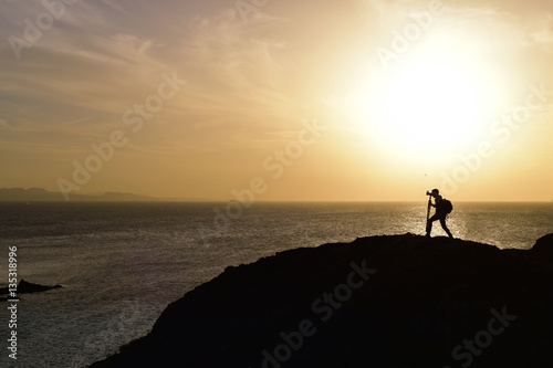 man taking a picture at dusk