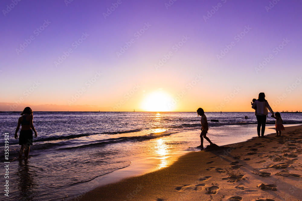 ワイキキビーチの夕日と人影