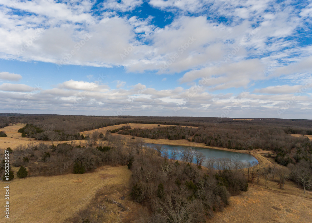 Aerial view of midwester wooded area with lake
