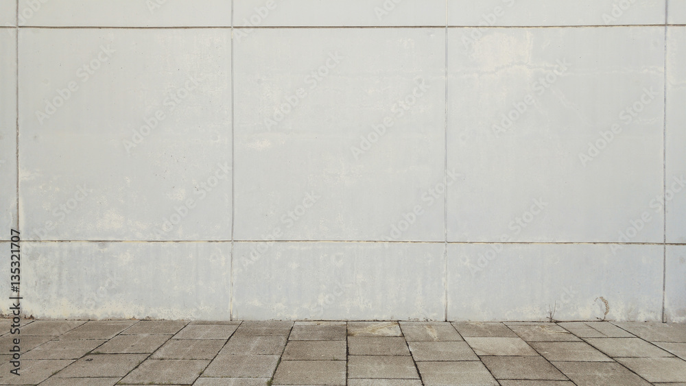 Urban street background. White wall and grey tiled floor. Copy space for Editor's text.