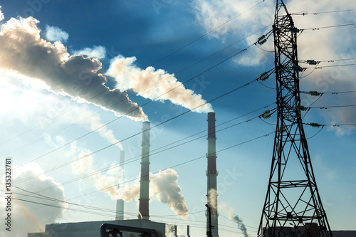 Factory chimneys smoke in the background of blue sky 2