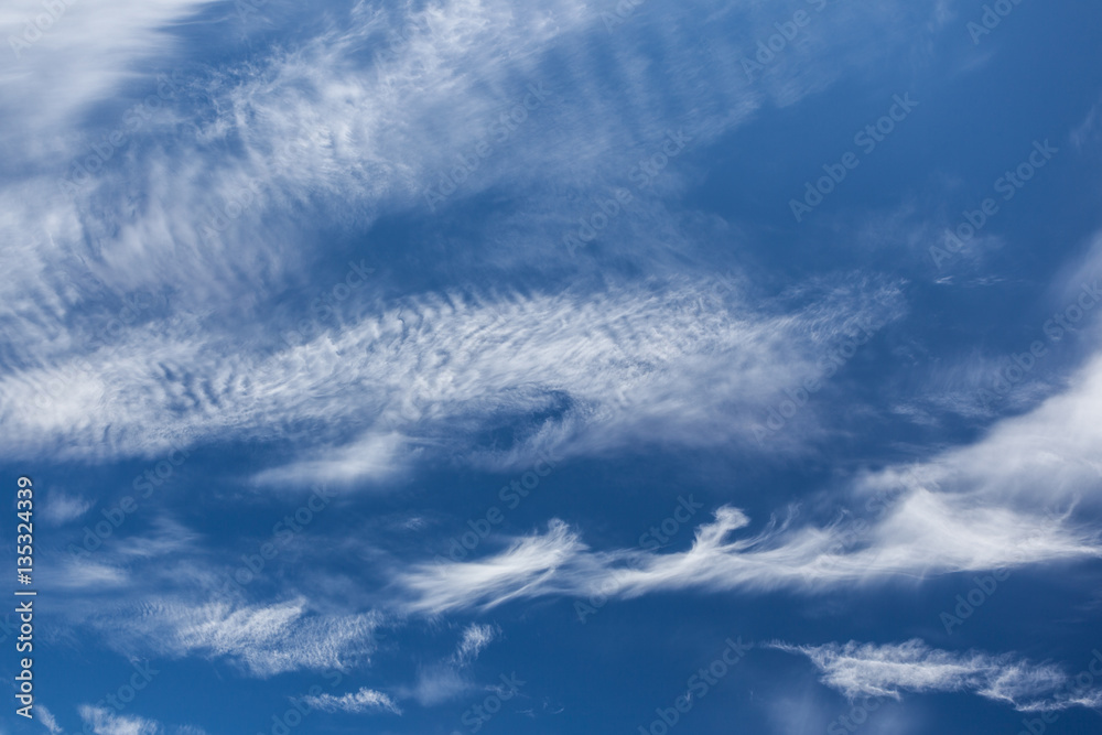 Wispy cirrus clouds blue sky