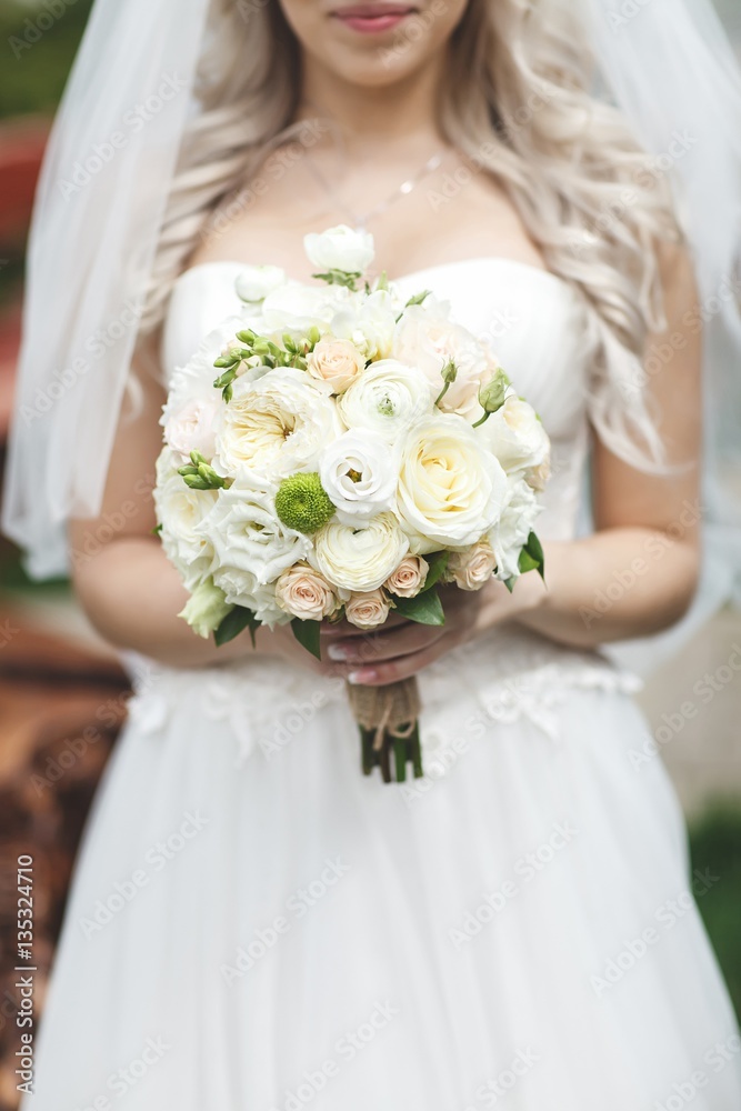 Bride holding wedding bouquet flowers