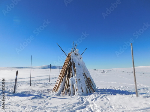 Wigwam on the covered with snow lowland